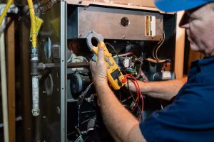 HVAC contractor at work repairing a furnace