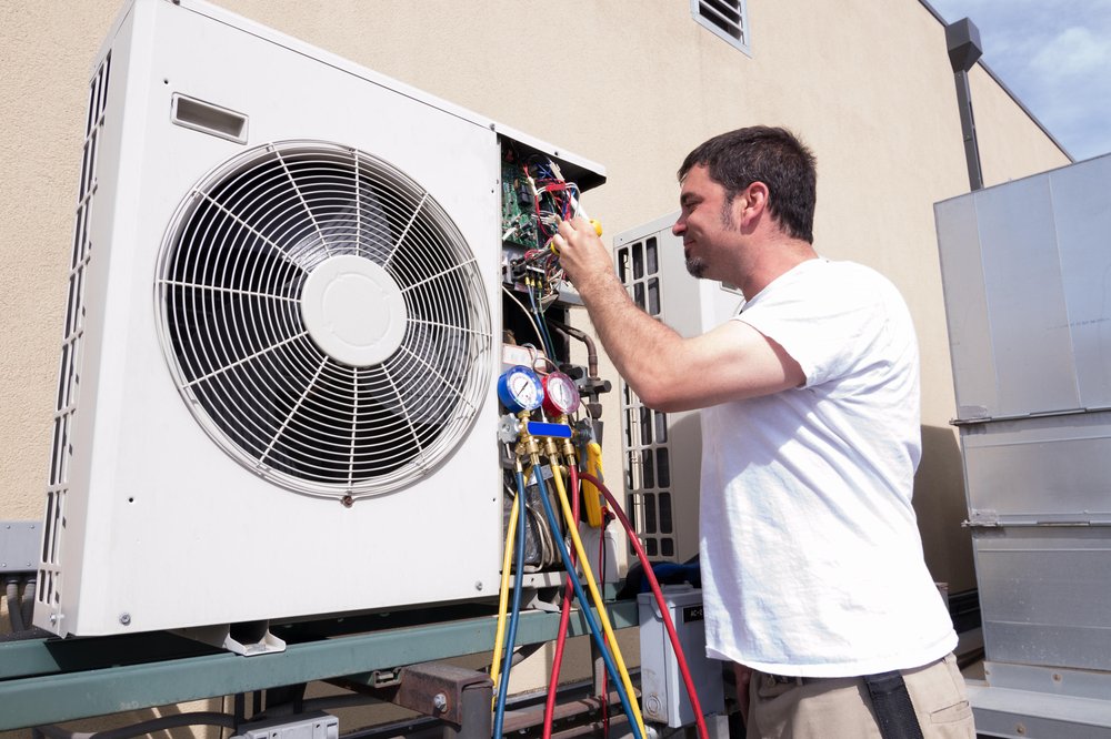 HVAC contractor at work repairing an air conditioner